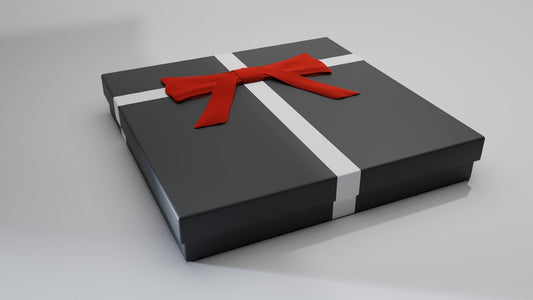 a black gift box with a red ribbon