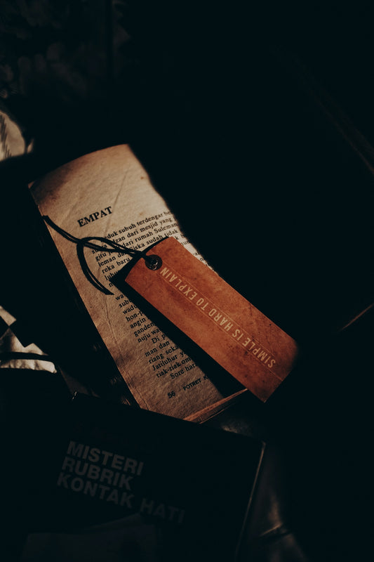 a book with a leather bookmark on top of it