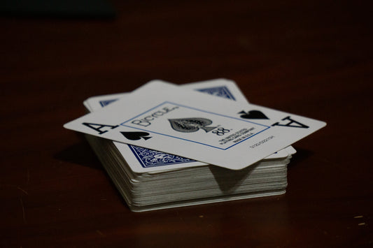 A stack of playing cards sitting on top of a wooden table