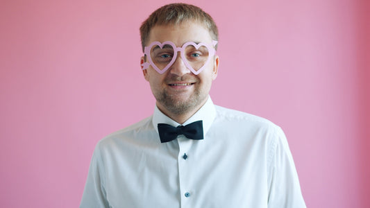 Man wearing heart-shaped glasses and bowtie