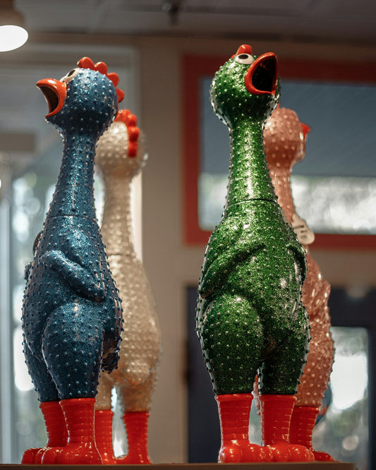 Four rubber chickens with red boots